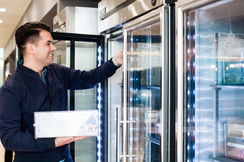 workplace experience staff stocking fridge milk